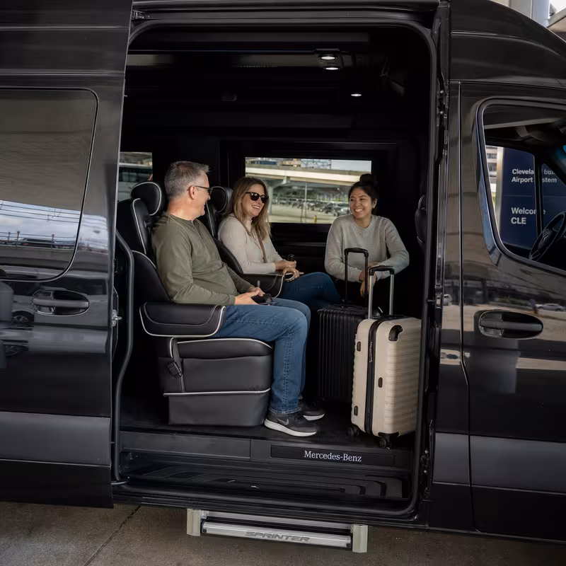 Passengers loading luggage while boarding an Cleveland group shuttle