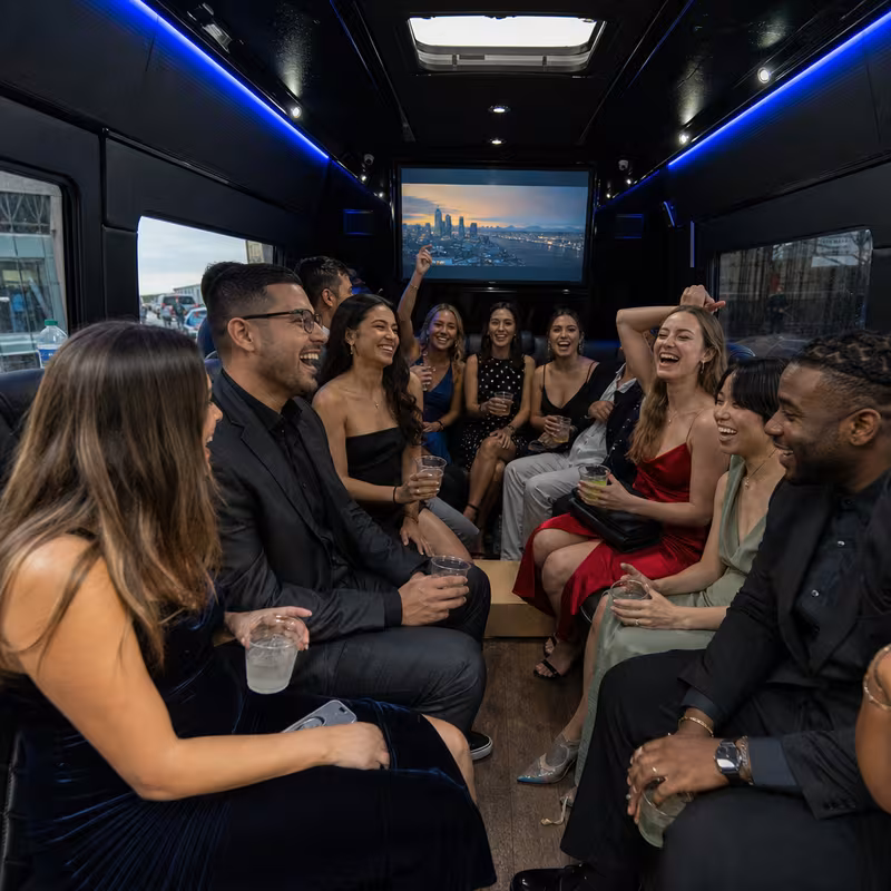 Party bus interior with wraparound leather seating and LED lighting in Cleveland