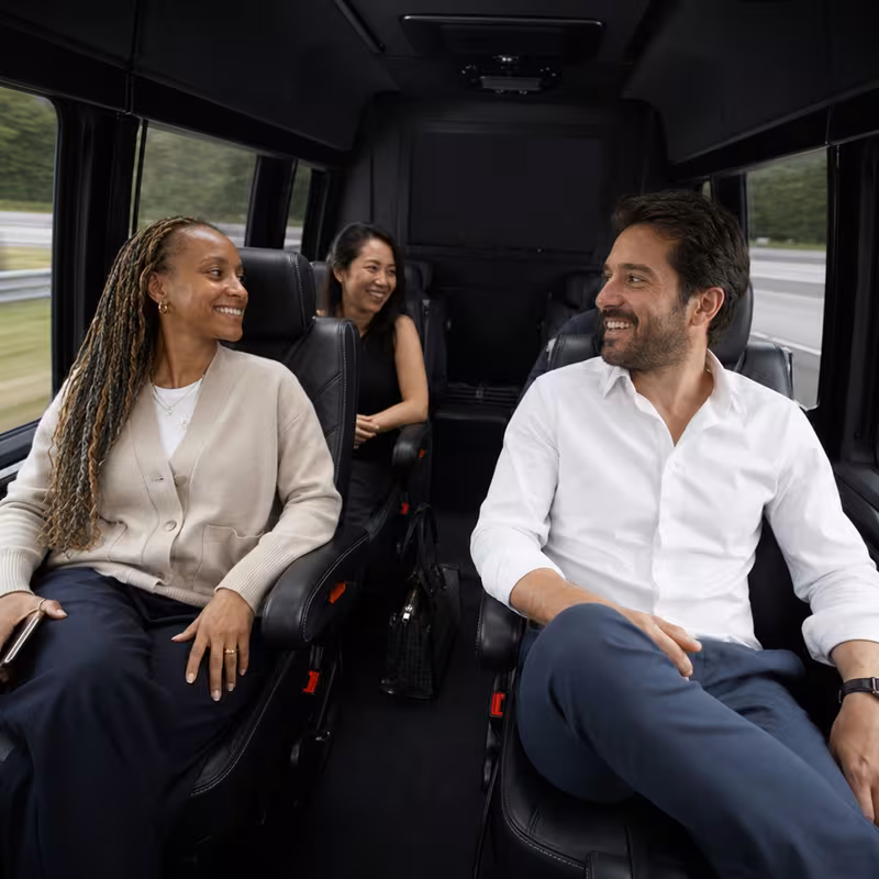 Group boarding a white charter bus for Corporate Transportation transportation in Cleveland