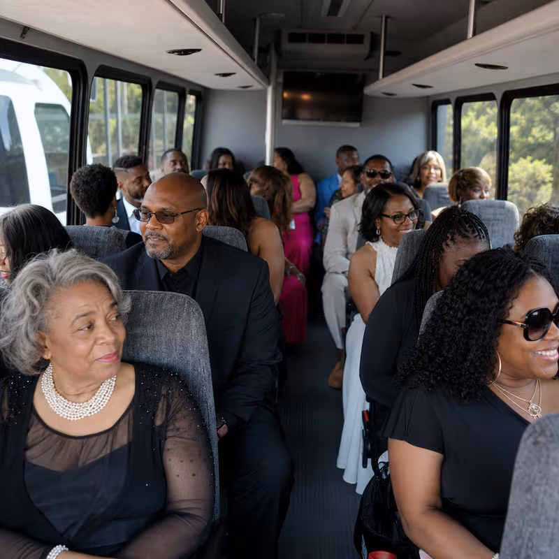 Group boarding a white charter bus for Private Event Transportation transportation in Cleveland