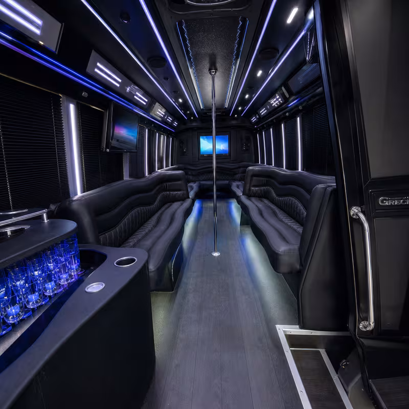 Party bus interior with wraparound leather seating and LED lighting in Cleveland